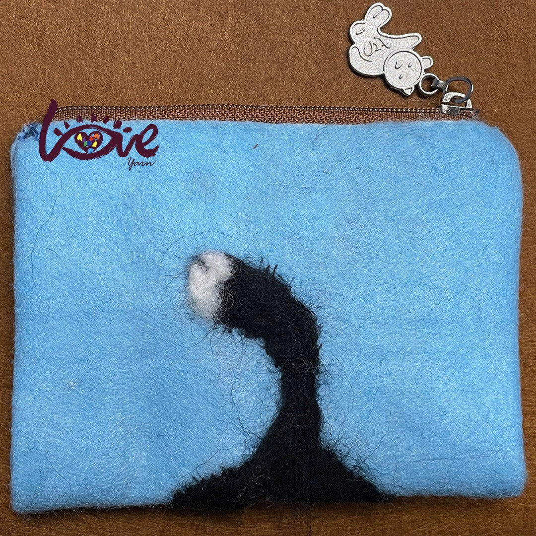 The black cat with a red woolen hat and scarf