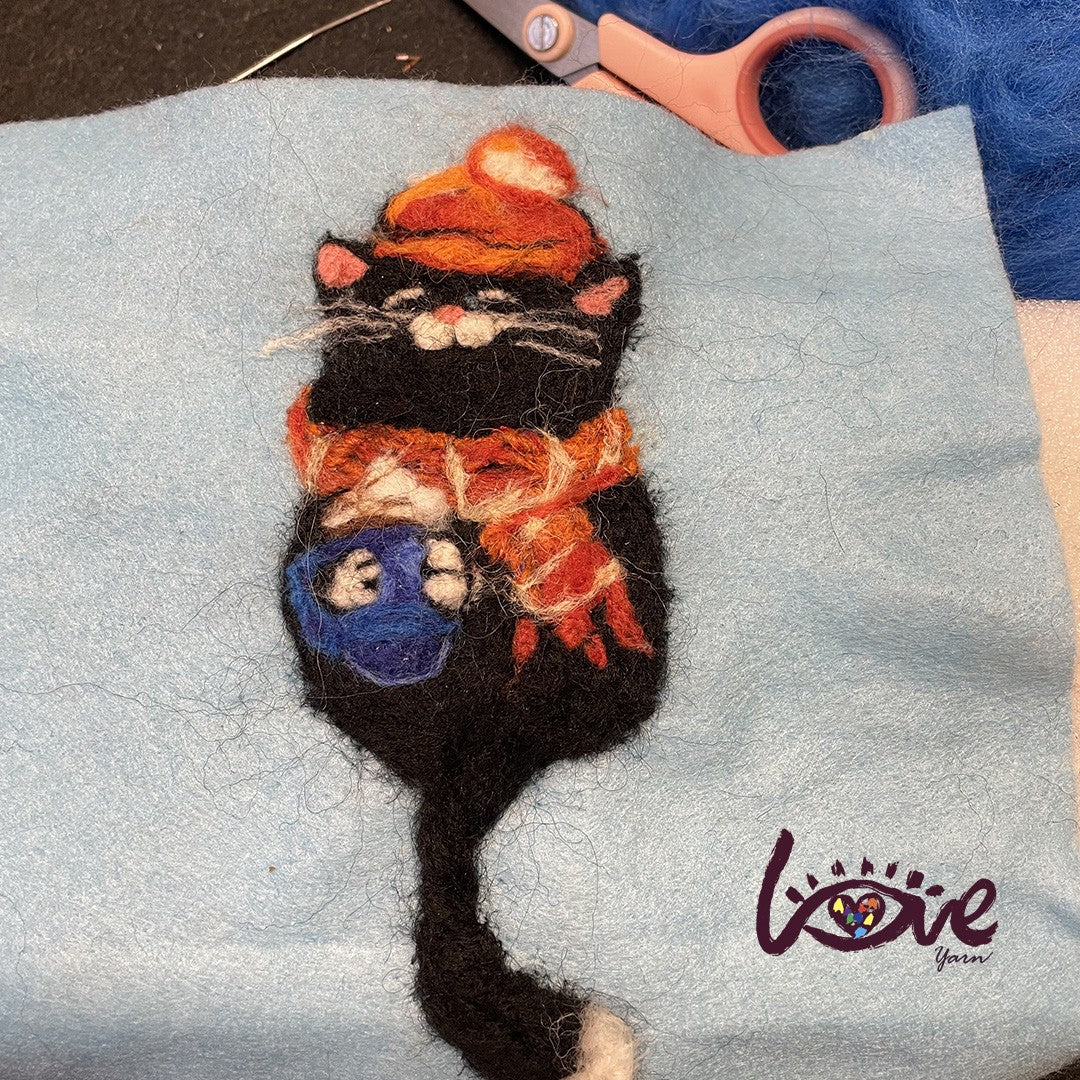 The black cat with a red woolen hat and scarf