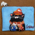 The black cat with a red woolen hat and scarf
