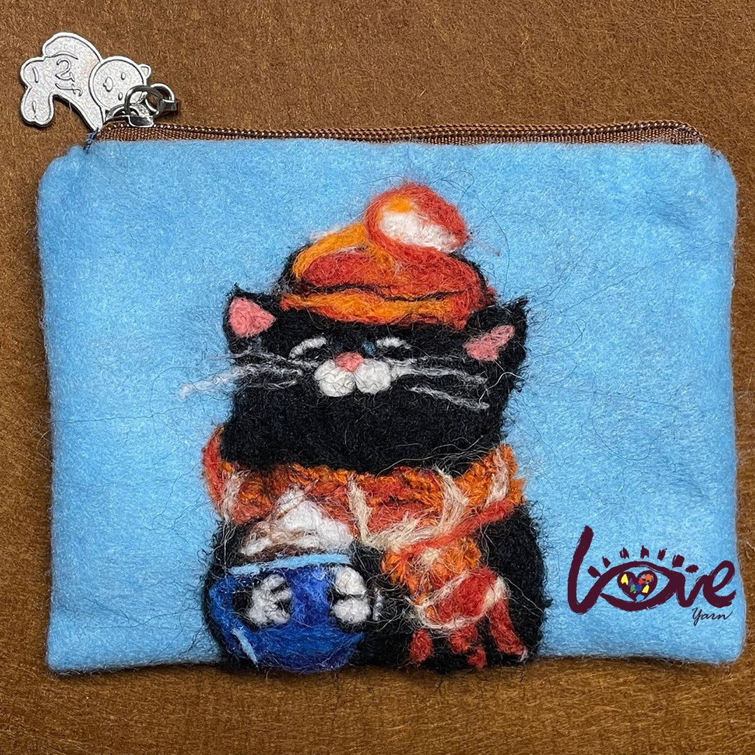 The black cat with a red woolen hat and scarf
