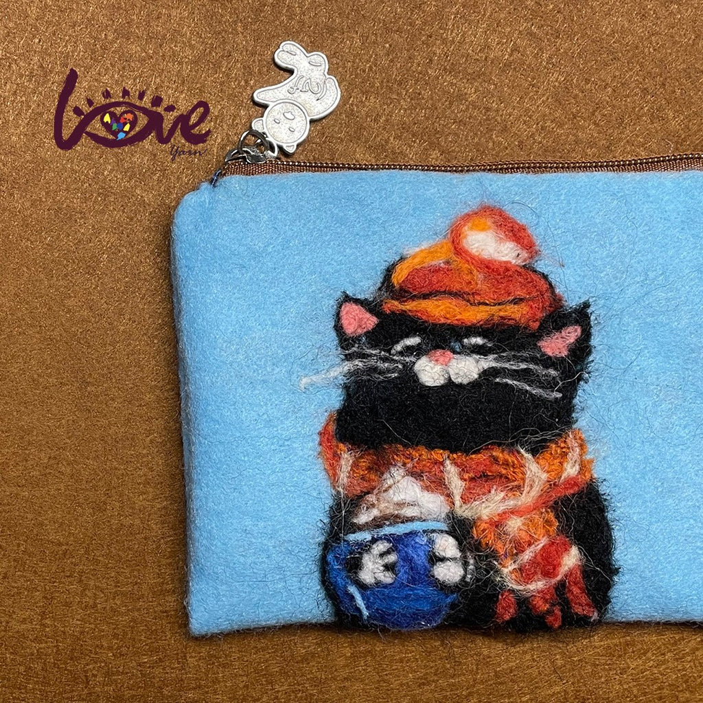 The black cat with a red woolen hat and scarf