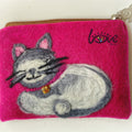 Oreo with a gold cat bell